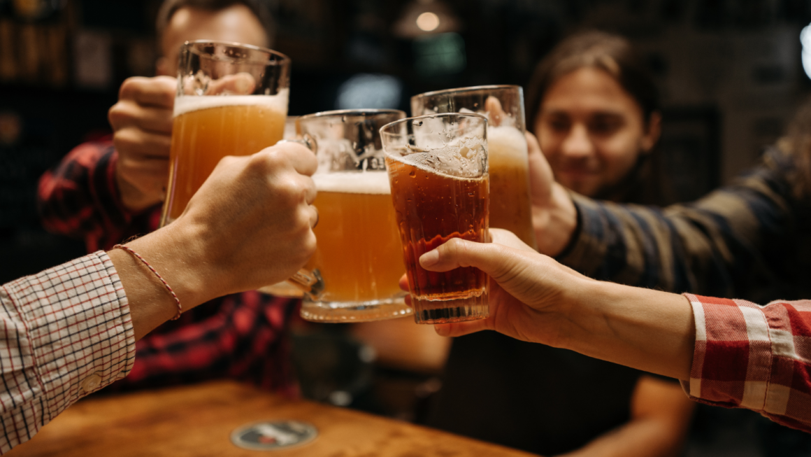 A group of friends drink beer after a live show.