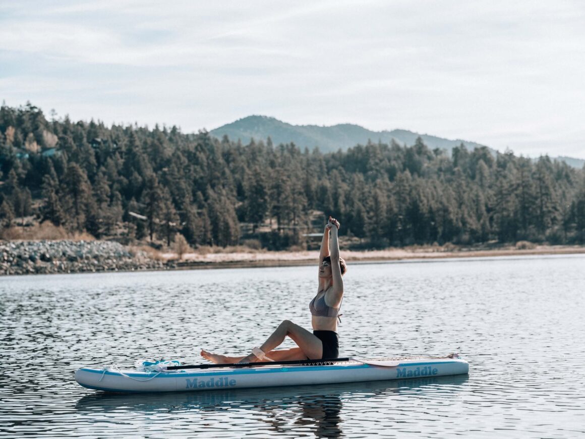 A woman doing yoga on a river in Asheville, NC.