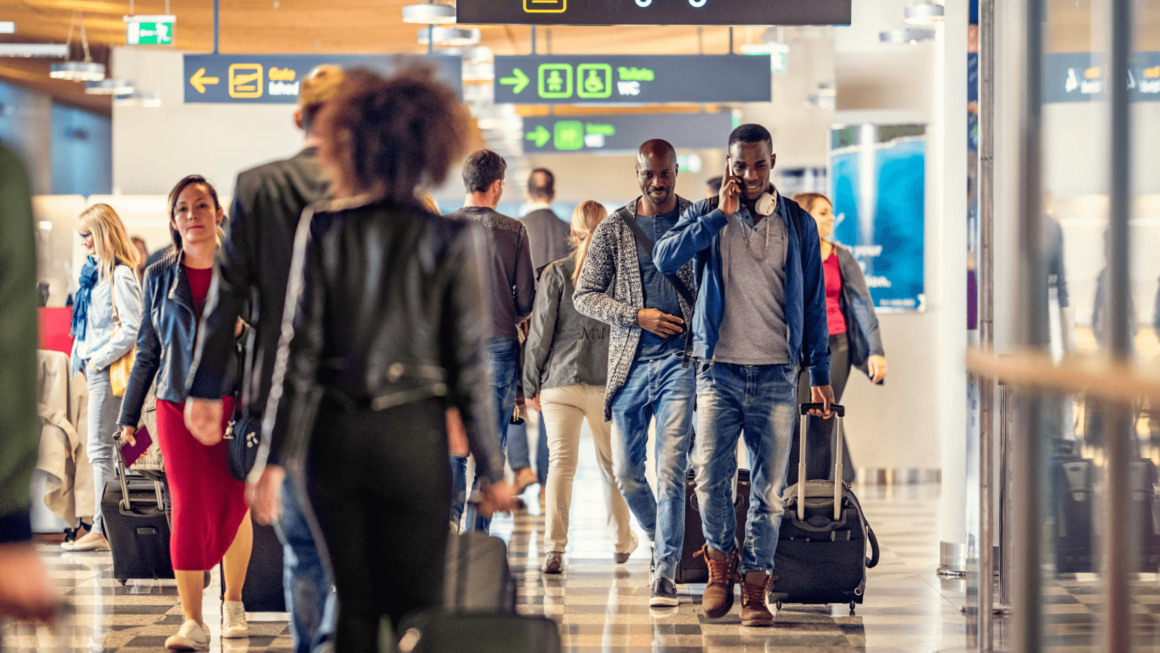 People walking through a busy airport.