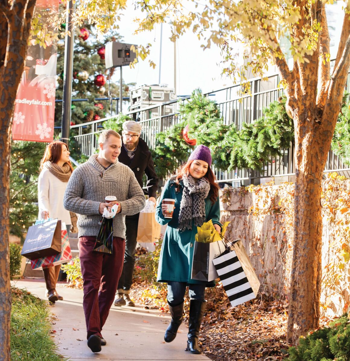 Holiday shoppers carry their purchases after shopping at the market in Wichita, Kansas.